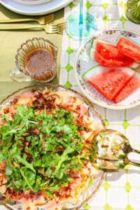 Cantaloupe Prosciutto Salad on a table with fruit