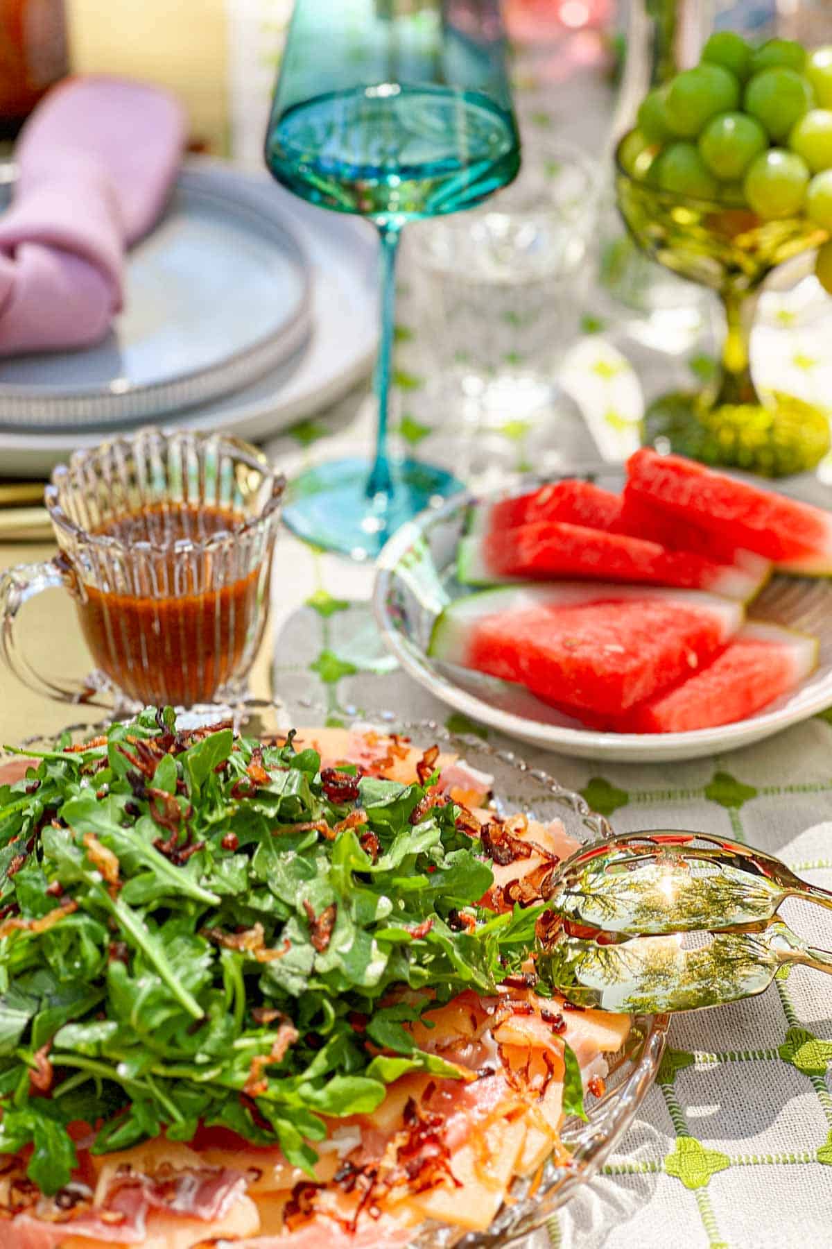 Cantaloupe Prosciutto Salad on a table with fruit