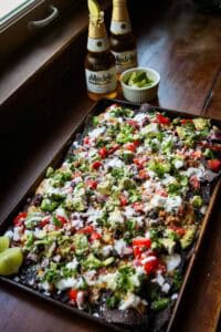 A tray of nachos with beer