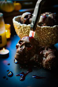 skull shaped cakes covered in a bloody sauce