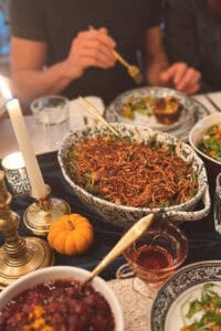 green bean casserole on a table of thanksgiving food